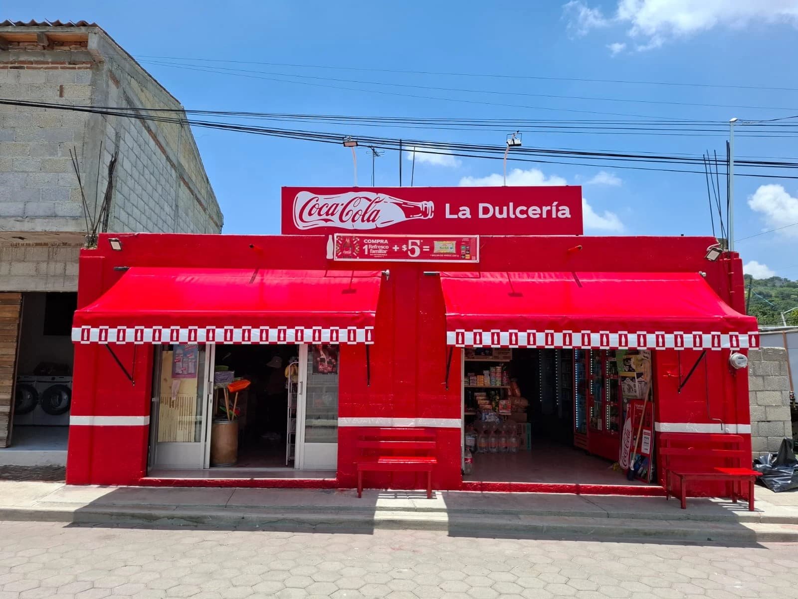 Fachada comercial completa con pintura, rotulación, anuncio y toldos instalados
